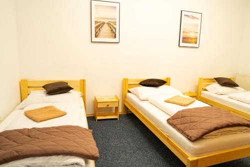 a room with three beds in a room at Penzión Oliver Humenné in Humenné