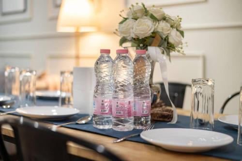 two bottles of water sitting on a table with plates at 10mins BTS Skytrain Onnut station in Amphoe Phra Khanong