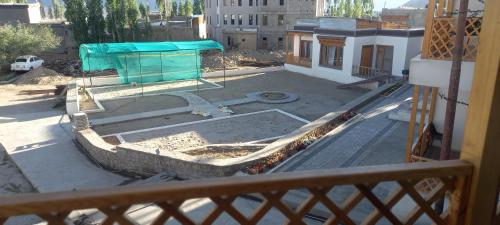 a view of a building under construction from a balcony at gultuk homestay airport road skalzangling leh ladakh in Leh