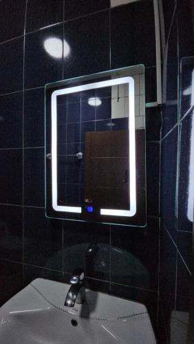 a mirror above a sink in a bathroom at Le conrad grand luxury hotel in Yaoundé