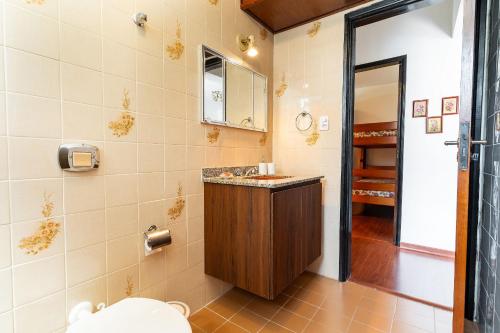 ein Badezimmer mit Waschbecken und Spiegel in der Unterkunft Lindo Apto no Centro de Serra Negra in Serra Negra