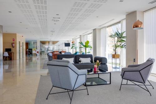 a lobby with a couch and chairs and a table at Daniya Alicante in Alicante