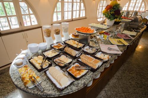 a buffet with many different types of food on a table at Hotel Monte Alegre in Rio de Janeiro