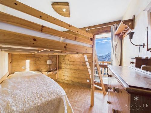 a bedroom with a bed in a room with a window at Charmant 3P Centre Station avec Parking et TV - FR-1-398-559 in La Rosière