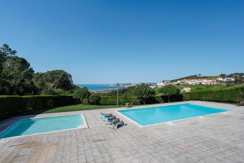a swimming pool with two lounges and two chairs next to it at Serene View - By SCH in Alvados