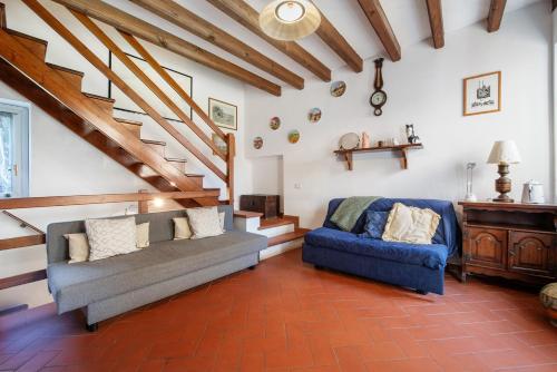a living room with a couch and a blue chair at Il Giardino Segreto Sulzano in Sulzano