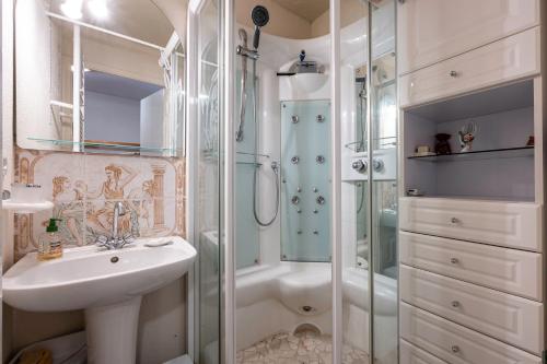 a bathroom with a shower and a sink and a tub at Valfréjus La montagne- App 123 in Valfréjus