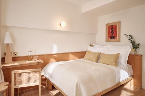 a bedroom with a large white bed with pillows at Elysée Montmartre Hotel in Paris