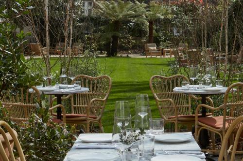 a group of tables and chairs in a garden at Miiro Templeton Garden in London