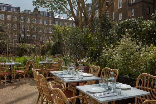 a group of tables and chairs in a garden at Miiro Templeton Garden in London