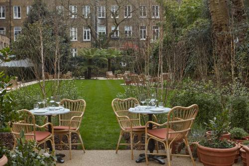a group of tables and chairs in a garden at Miiro Templeton Garden in London
