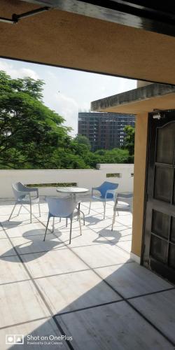 a patio with a table and chairs on a building at Cheerful two Bedroom Green Villa by Suvana Organics in Lucknow