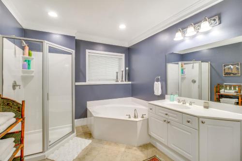 a bathroom with a tub and a sink and a shower at Game Room and Fire Pit Riverfront Home in Ellijay! in Ellijay