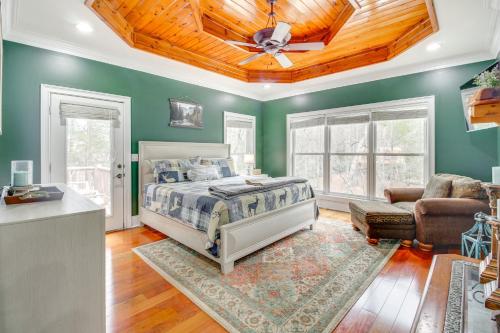 a bedroom with green walls and a bed with a ceiling at Game Room and Fire Pit Riverfront Home in Ellijay! in Ellijay