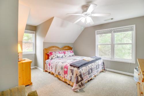 a bedroom with a bed and a ceiling fan at Game Room and Fire Pit Riverfront Home in Ellijay! in Ellijay
