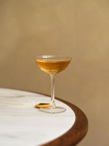a drink in a glass sitting on a table at Miiro Templeton Garden in London
