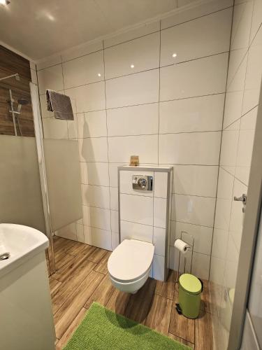 a small bathroom with a toilet and a sink at 7th Room Guest House in Oświęcim