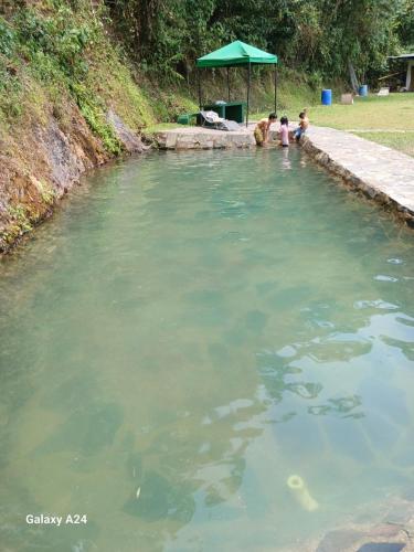 two children playing in a pool of water at EL Refugio in La Vega
