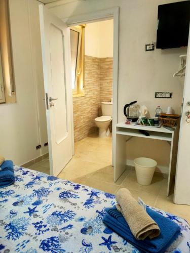 a bedroom with a bed and a bathroom with a toilet at Bed and fly Aeroporto Catania in Catania