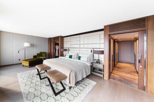 a hotel room with a large bed and a chair at The Marmara Taksim in Istanbul