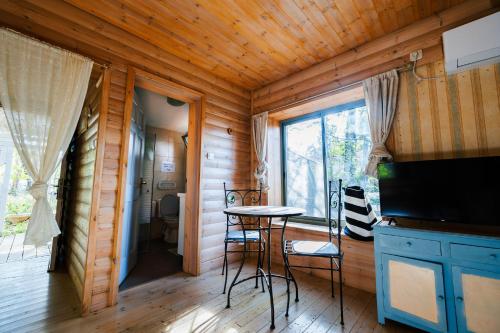 a living room with a table and a window at GREEN VACATION in Bet Hillel