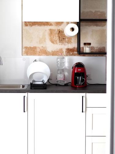 a kitchen counter with a toaster and a tea kettle at C'era una volta in Modugno
