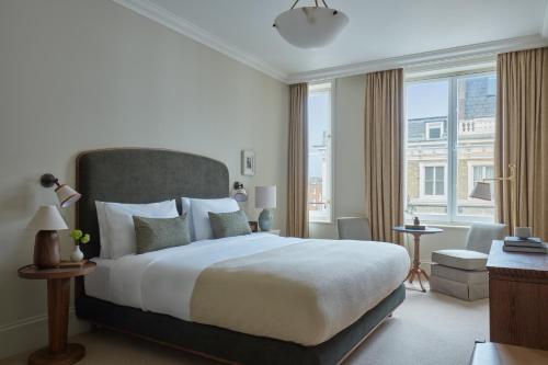 a bedroom with a large bed and a large window at Miiro Templeton Garden in London