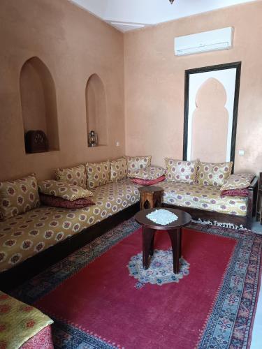 a living room with a couch and a table at Dar Riad Niama in Taroudant