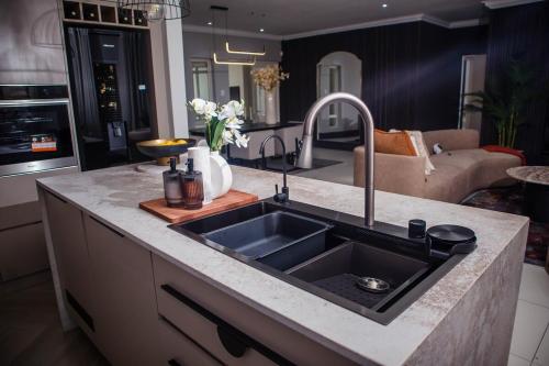 a kitchen counter with a sink in a kitchen at 5 On Dana in Gqeberha