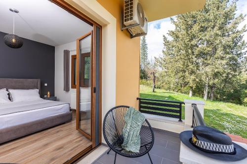 a bedroom with a bed and a balcony at Spiros country home in Áno Korakiána