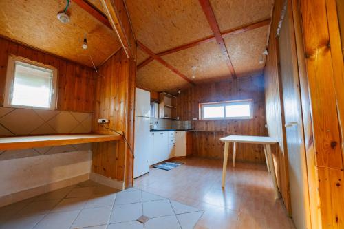 a small kitchen with wooden walls and wooden floors at GREEN VACATION in Bet Hillel