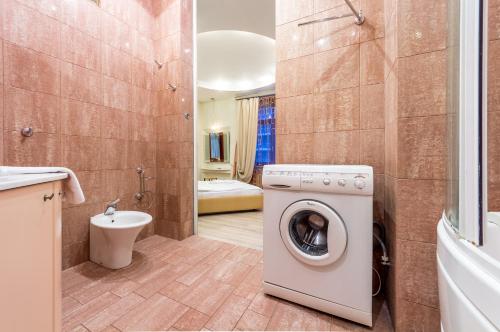 a bathroom with a washing machine and a toilet at Cheap Apartments in Kyiv