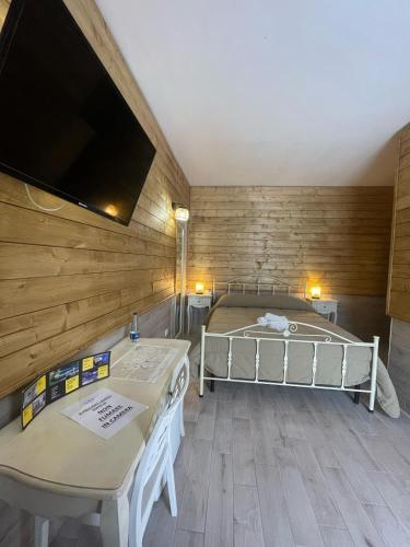 a bedroom with a bed and a flat screen tv at Re Sole Resort&Spa in Grottaglie