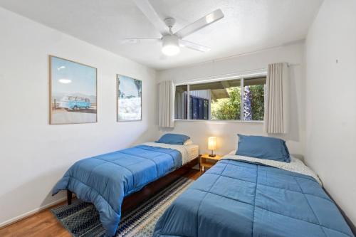 a bedroom with two beds and a window at 11 Canyon Terrace by Catalina Island Vacation Rentals in Avalon