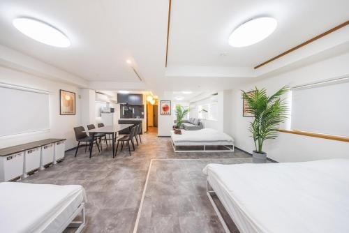 a room with two beds and a dining room at R201-Shinjuku 13 min Up to 8 people 60 sqm Full renovation Roppongi and Tsukiji direct access Family group 7 min to Ochiai Minami Nagasaki Station in Tokyo