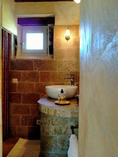 a bathroom with a white sink and a window at Domaine De Frevent in Échouboulains