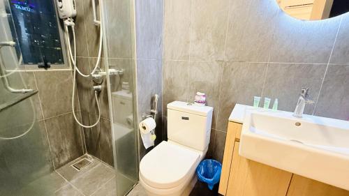 a bathroom with a toilet and a shower and a sink at Colony Service Suites Kuala Lumpur in Kuala Lumpur