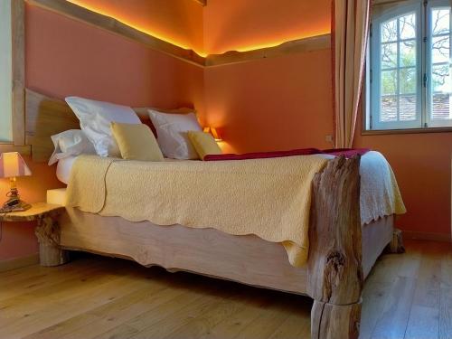 a bedroom with a large bed in a room at Domaine De Frevent in Échouboulains
