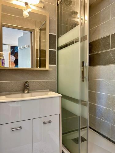une salle de bain avec un lavabo et une douche dans l'établissement L'ocre du Sud - 6 pers - Histoire de clés, au Cap d'Agde