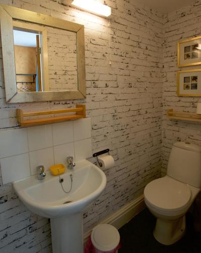 a bathroom with a white sink and a toilet at The Gallery in Blackpool