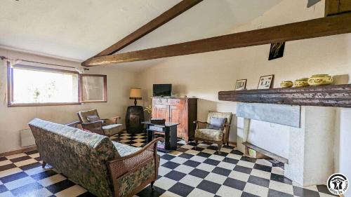 an old living room with chairs and a fireplace at L'ouastadet in Aspret-Sarrat