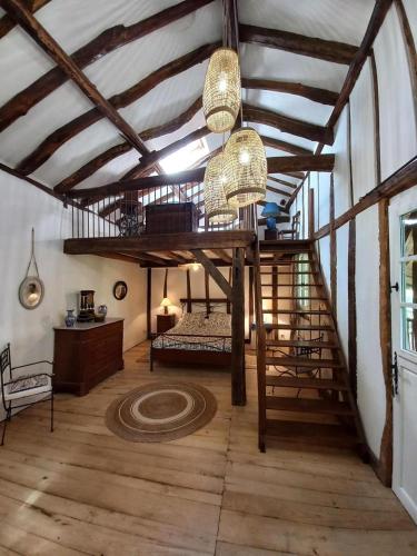 a room with a loft with a bed and a staircase at Chez pailhas in Régades