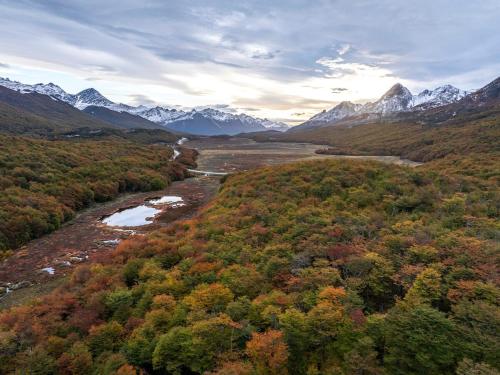 an aerial view of a valley with a river and mountains at DOMO en Ushuaia Glamping in Ushuaia