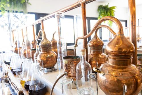 a row of copper vases sitting on a table at Protea Hotel by Marriott Mossel Bay in Mossel Bay