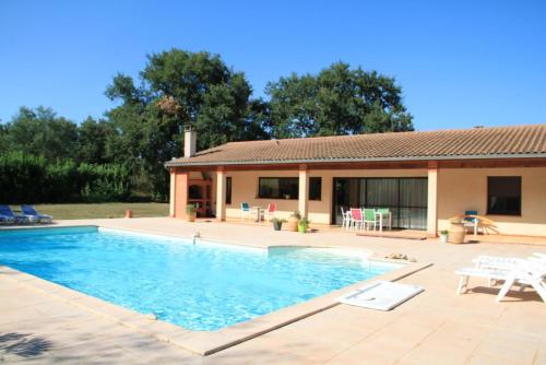 a swimming pool in front of a house at Le petit clot de pey in Esperce