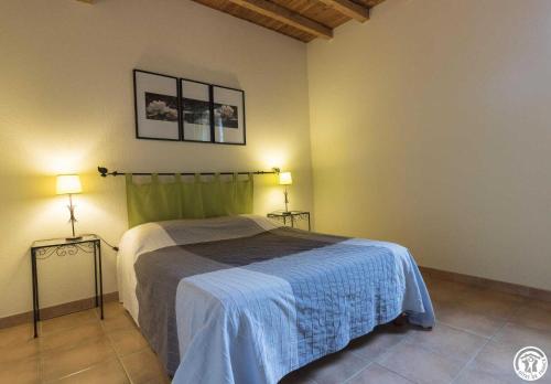 a bedroom with a bed and two lamps in it at Granny in Pibrac