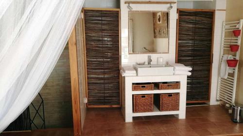 a bathroom with a sink and a mirror at Gîte Baugnac N°2 in Lavalette