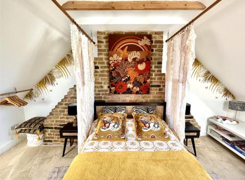 a bedroom with a bed and a brick wall at Golspie House, Margate in Margate