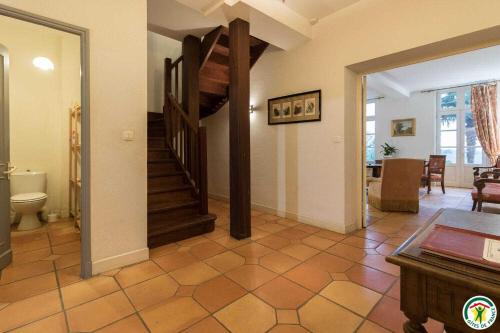 a room with a staircase and a living room at Le parc des moutous in Aurin