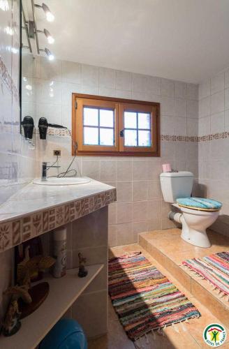 a bathroom with a sink and a toilet in it at Au village in Roques Sur Garonne
